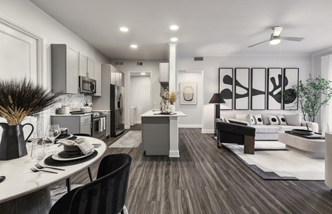 an open living room and kitchen with a table and chairs